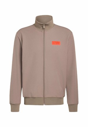 Light brown zip-up jacket with high collar, ribbed cuffs and hem, featuring an orange logo patch on the left chest. Smooth texture.