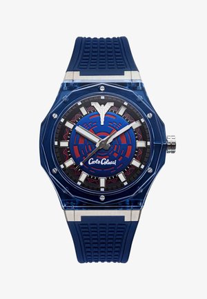 Blue wristwatch with patterned face, silver hour markers, white hour and minute hands, and blue textured rubber strap, branded "Carlo Chuci."