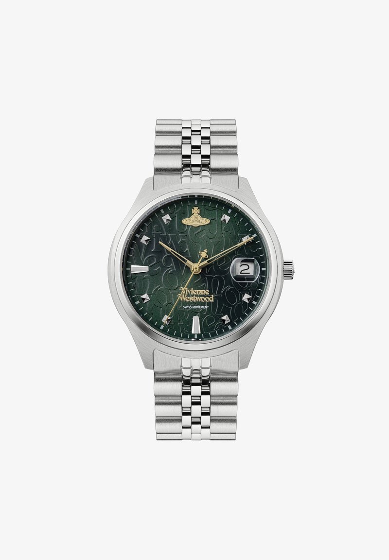 Klokke i rustfritt stål med en grønn mønstret urskive, gullakenter og datovisning. Armbåndet i sølvfarget metallnett tilfører tekstur.