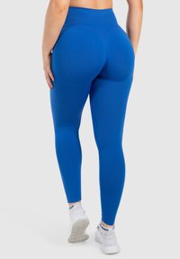 Höga leggings i starkblått med en slät yta, med en konturerad design och en midjeresår för extra stöd.