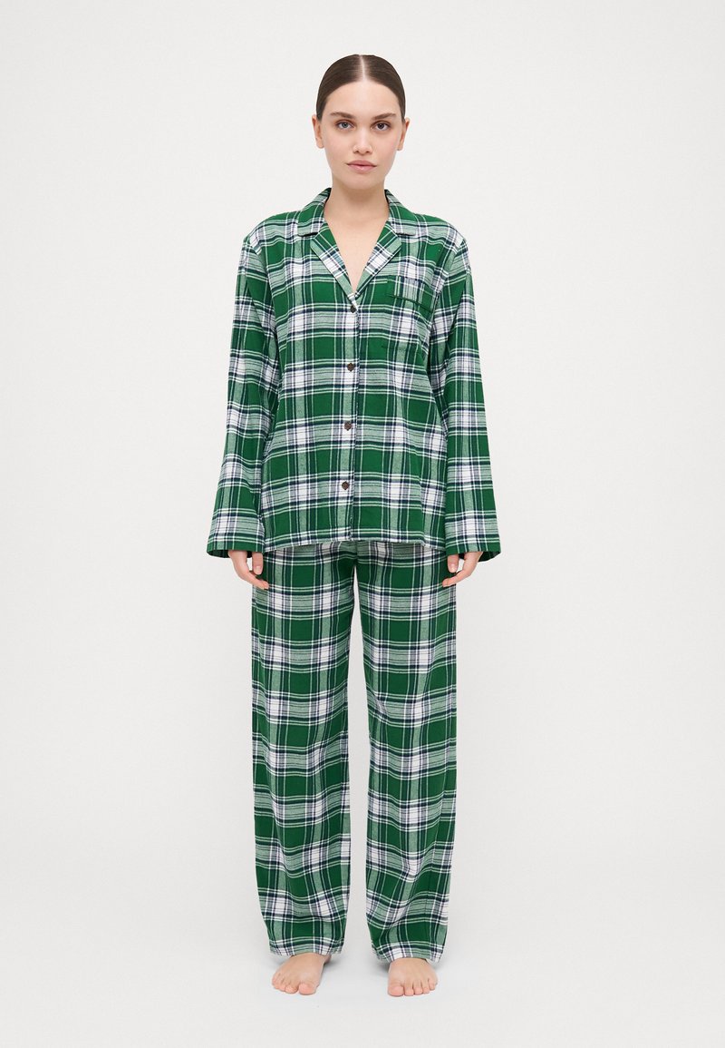 Green plaid patterned pajama set with a button-up top and loose-fitting pants, made of soft fabric, featuring white accents.