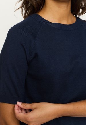 Navy blue knit sweater featuring short sleeves, a ribbed crew neckline, and subtle seam details on the shoulders. Soft texture and fitted shape.
