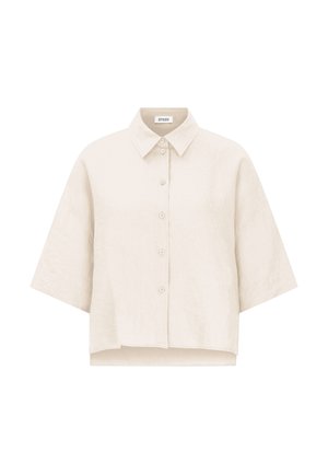 Beige oversized kortærmet skjorte med knapper, krave og let kortet kant.