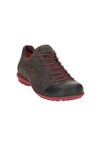 Casual low-cut suede sneaker with black toe cap, dark red laces, and matching red rubber sole, angled to show outer side and front.