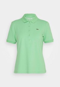 Green polo shirt made of lightweight fabric, featuring a classic collar, button placket, and embroidered logo on the left chest.