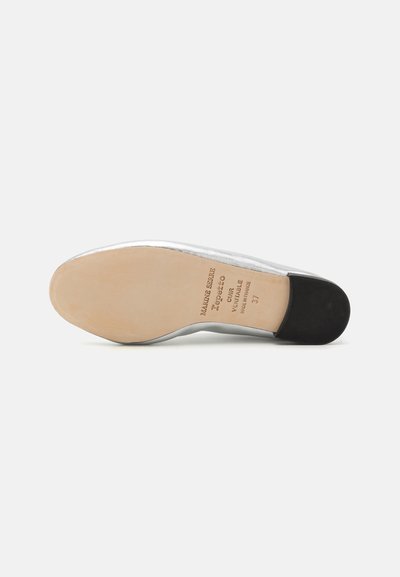 Silver leather shoe sole with a smooth, rounded shape, featuring a tan base and black rubber heel; marked with brand and size details.