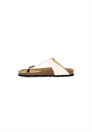 Infradito di un leggero beige con una soletta in sughero, dettagli neri e un distintivo design T-strap; suola piatta con superficie texturizzata.