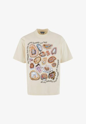 Kremowa bawełniana koszulka z krótkim rękawem, zdobiona różnymi grafikami kamieni agatu w ziemistych odcieniach oraz czarnym tekstem wokół wzoru. Okrągły dekolt.