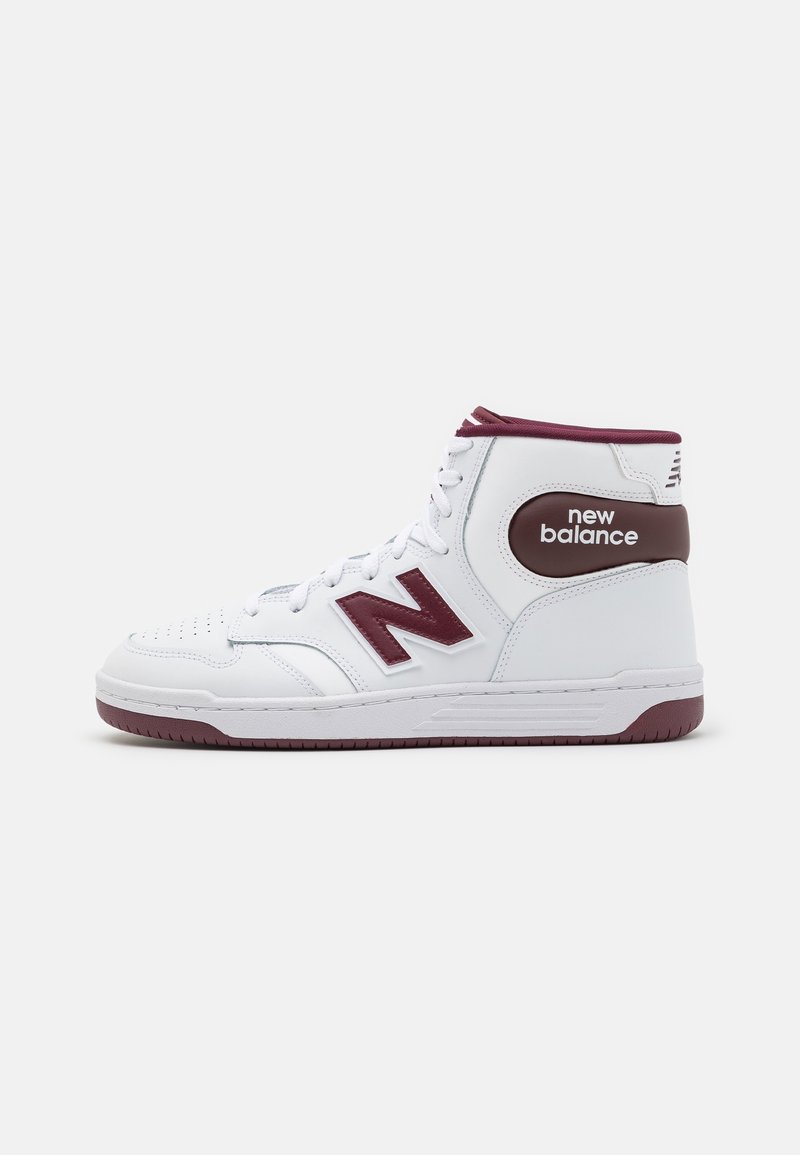 High-top sneakers in white leather with maroon accents, featuring perforated toe, padded collar, and a prominent 'N' logo on the side.