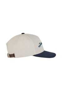Gorra de algodón beige con visera azul oscura, presenta un logo verde en el frente, un botón azul oscuro en la parte superior y una correa ajustable marrón.