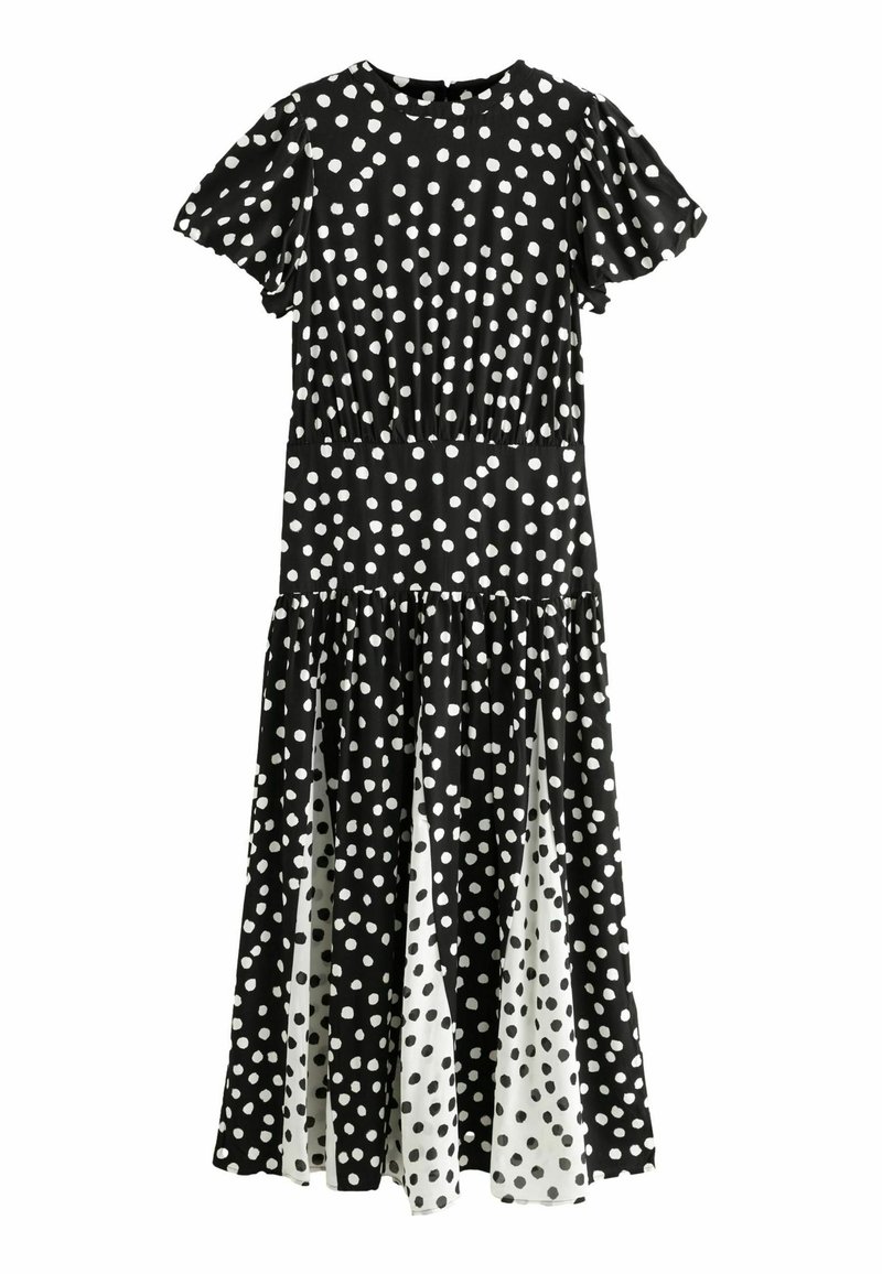 Zwart-witte jurk met stippen, korte pofmouwen, een getailleerde taille en een gelaagde rokdesign, met een contrasterend wit paneel aan de zoom.