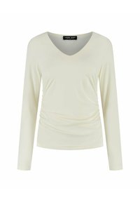 Lichtcrème top met lange mouwen en een V-hals, geplooide zijdetails, een soepele structuur en een label met de tekst "LADY DAY."
