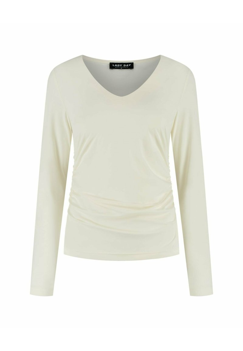 Lichtcrème top met lange mouwen en een V-hals, geplooide zijdetails, een soepele structuur en een label met de tekst "LADY DAY."