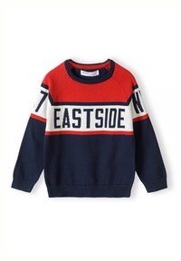 Pull en maille bleu marine avec des accents rouges et crème, comportant le texte "EASTSIDE" et des détails rayés. Poignets et col côtelés.