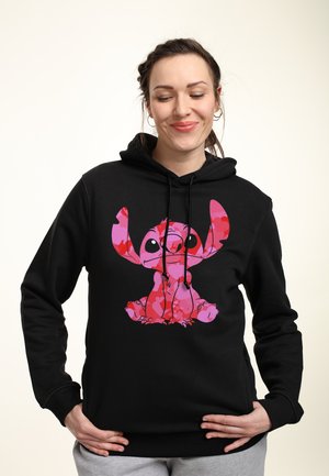 Black hoodie with a front design of a pink character. Features a drawstring hood and ribbed cuffs. Material appears soft and comfortable.