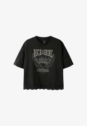 T-shirt court noir à manches courtes avec inscription « Rock & Shine Future is female », motif cœur ailé et bordure en dentelle à l’ourlet.
