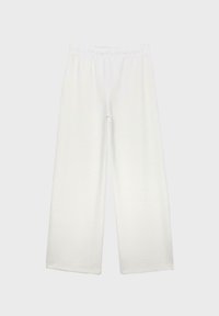 Pantalon blanc ample avec taille élastique, jambes larges et droites, présenté sur un fond clair uni.