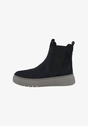 Black suede ankle boot with elastic side panels, textured grey sole, and stitched detailing along the base.