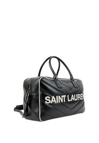 Sac de sport en cuir noir avec passepoil blanc et texte "SAINT LAURENT" en grandes lettres blanches sur le côté, avec deux poignées supérieures et une bandoulière latérale.