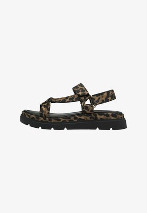 Leopard print sandal with black rubber sole, adjustable straps, and a flat design. Features metallic accents and a textured upper.