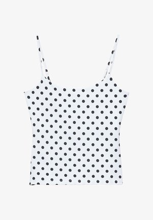 Top caraco blanc avec fines bretelles et un motif à pois noirs recouvrant uniformément le tissu.