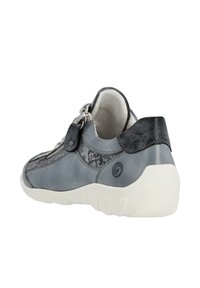 Gray leather sneaker with textured accents, a smooth back, and a white rubber sole. Features a decorative zipper and adjustable detail.