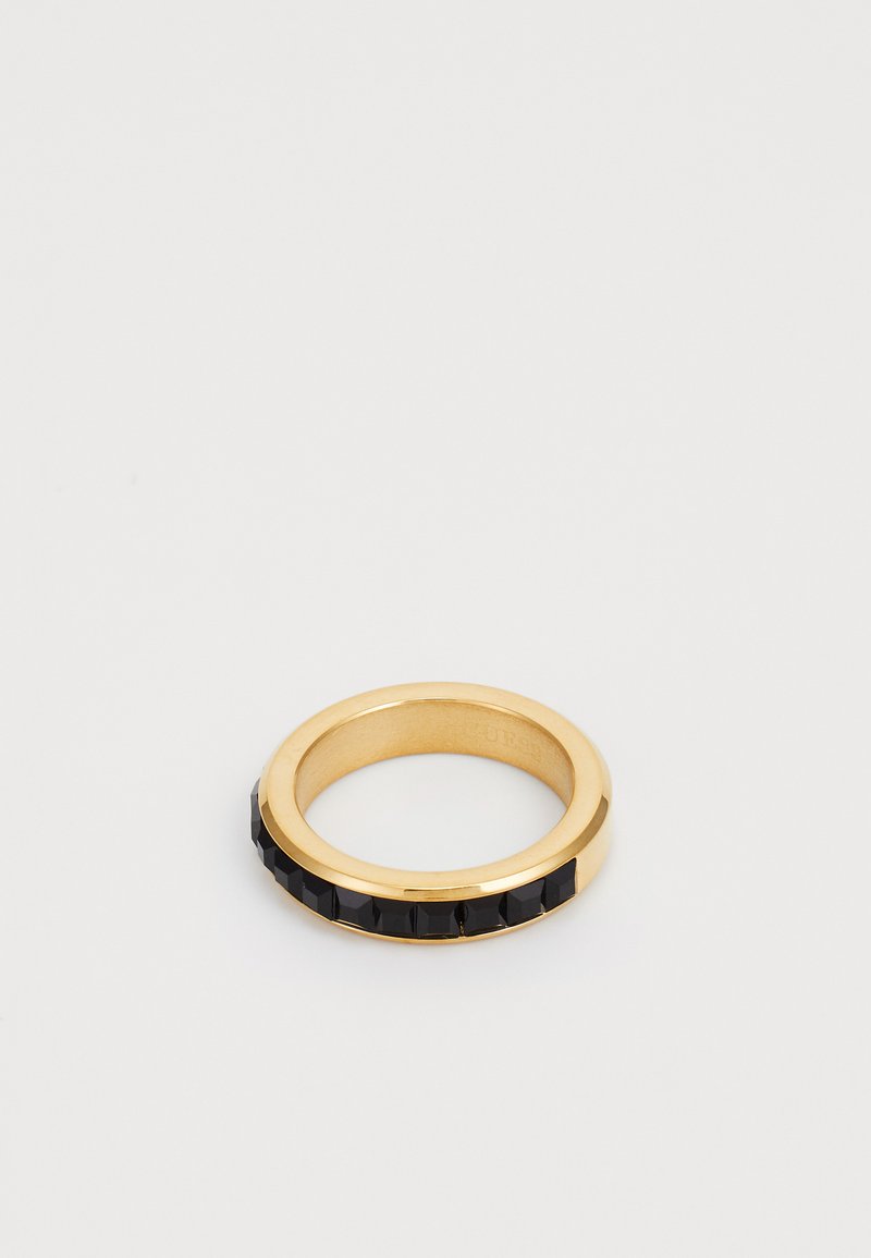 Gold ring featuring a black faceted band. The ring has a smooth inner surface and a textured outer edge with glossy black accents.
