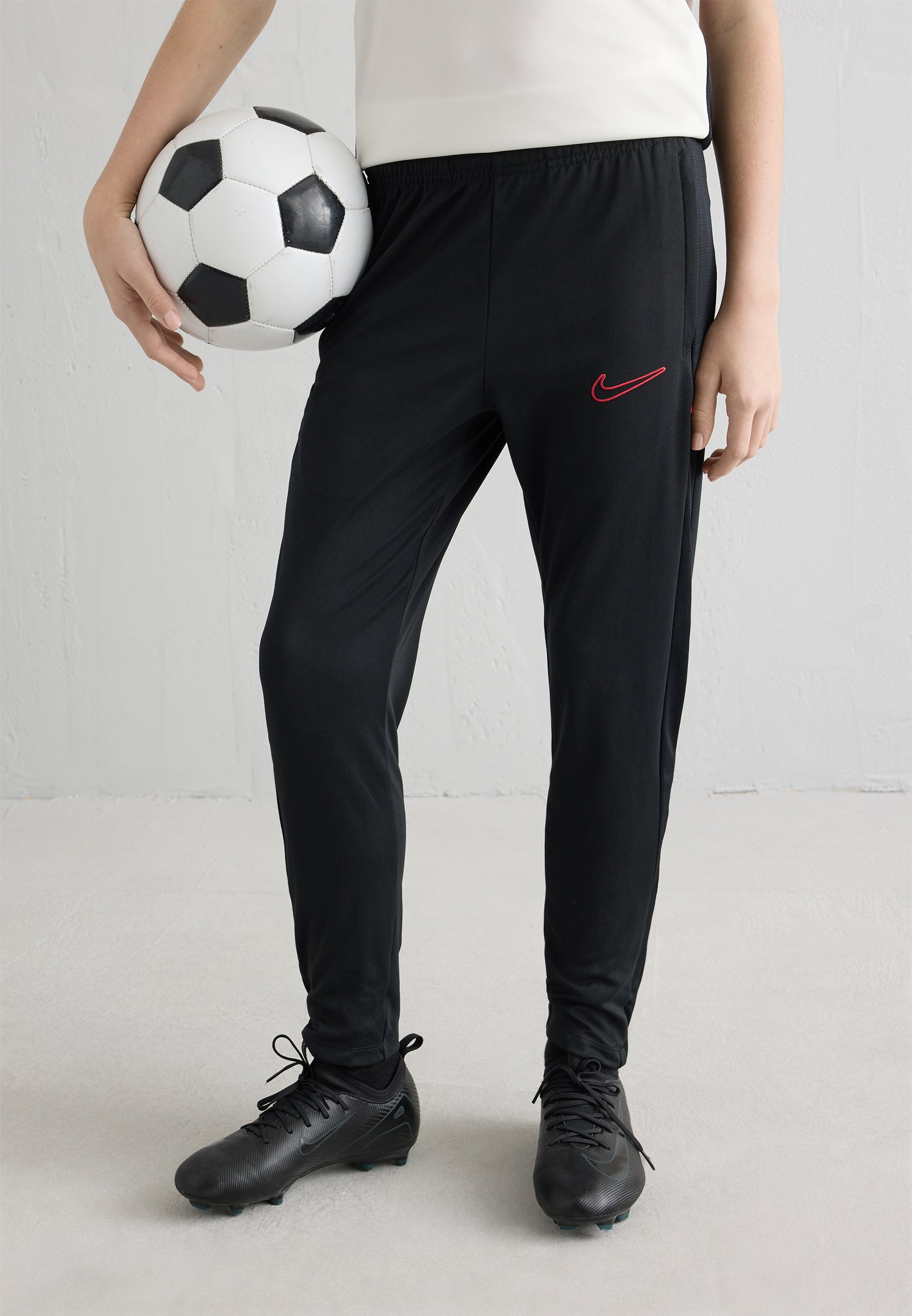 black nike tracksuit bottoms red tick