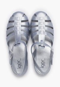 Light gray plastic sandals with a strappy design, closed toe, and adjustable ankle strap. Features a smooth textured insole.
