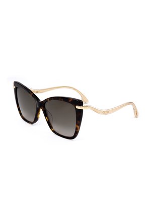 Occhiali da sole stile cat-eye con lenti sfumate scure, montatura anteriore in tartaruga e aste beige curve traslucide.