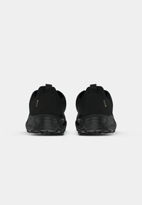Black athletic shoes, featuring a smooth fabric upper, reinforced heel, and textured rubber sole. Minimalist design with a simple silhouette.