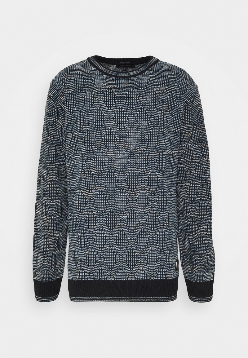 Pull à manches longues et col rond avec un motif géométrique texturé noir et blanc, poignets et ourlet côtelés, présenté sur fond blanc.