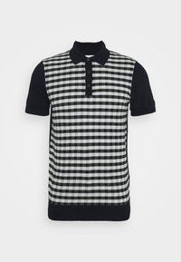 Polo à manches courtes noir et blanc avec panneau avant à carreaux et col, manches et ourlet noirs unis.