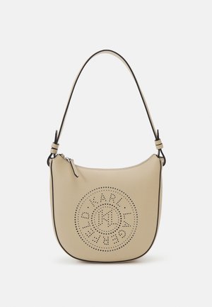 Beige leather handbag with a semi-circular shape, featuring perforated logo design and contrasting black trim. Single shoulder strap included.