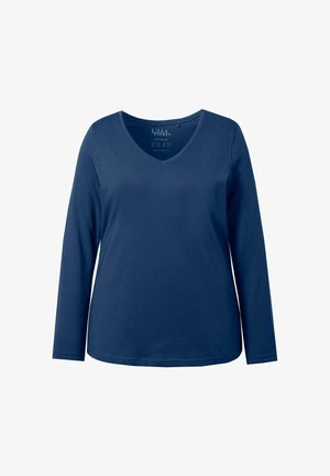 Women's navy blue long-sleeve V-neck cotton top with a relaxed fit and subtle stitching along the hem and cuffs.