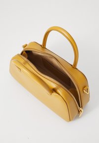 Yellow leather handbag with a structured shape, dual zip closures, top handle, and a smooth texture. Interior is brown with an inset pocket.