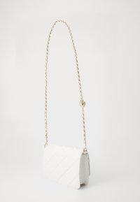 White quilted crossbody bag with gold chain strap and small round gold charm, shown against a plain white background.