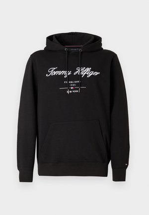 Black hooded sweatshirt made from cotton, featuring front pocket, drawstrings, and white logo text with established date and location details.