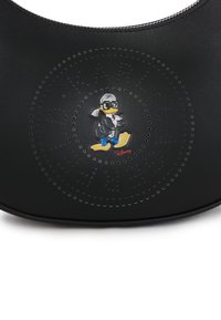 Black leather handbag featuring a perforated circular design and a colorful Donald Duck emblem. Zipper closure at the top.