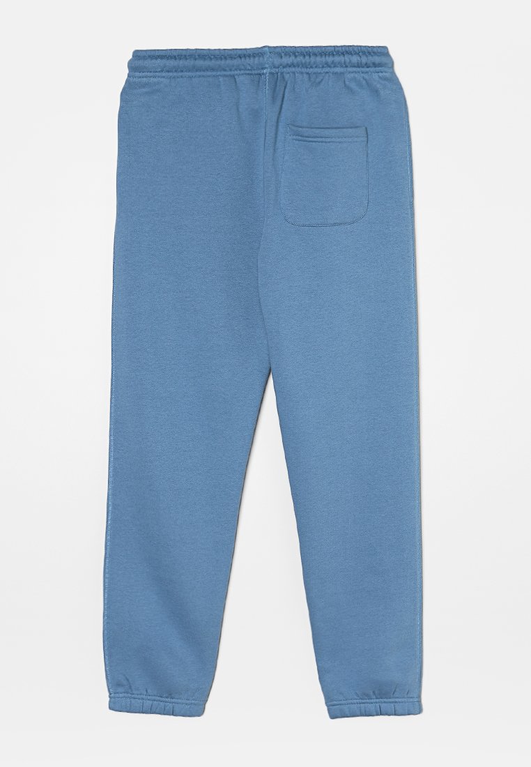 Blauwe sweatpants van zachte stof, met een elastische tailleband, cuffed enkels en een enkele achterzak. Souple textuur met een uniforme kleur.