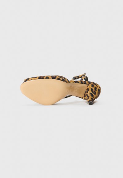 Pantof cu toc înalt, cu imprimeu de leopard, având vârful ascuțit și bretea la glezna. Prezintă o parte superioară din țesătură texturată și o talpă netedă din cauciuc bej.
