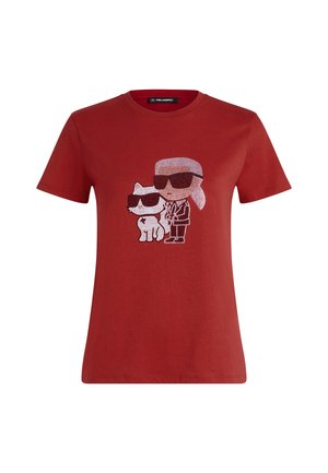 Red cotton t-shirt featuring a graphic design of two characters, one resembling a person and the other a cat, both wearing black sunglasses.