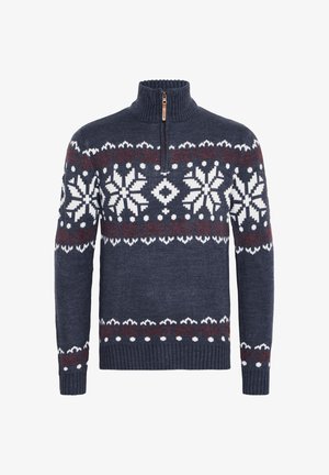 Tumši zils adīts džemperis ar augstu apkakli, pus-iezips un baltām sniegpārsliņu rakstiem, ko akcentē sarkanas krāsas elementi krūtīs un piedurknēs.