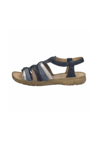 Women's casual sandal with navy, silver, and tan straps, cushioned sole, and ankle strap for adjustable fit and comfort.