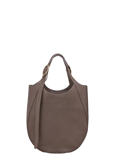 Brown leather tote bag with rounded bottom, adjustable strap with gold buckles, and short handles on a white background.