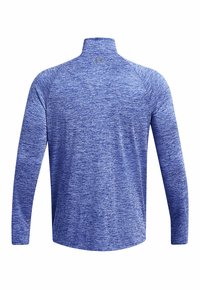 Langsleeve sportshirt in gemêleerd blauwe stof. Voorzien van een mock neck en naadloos schouderontwerp voor comfort. Textuur oppervlak.