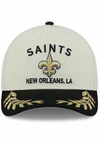 White cap with black brim, embroidered "SAINTS" and fleur-de-lis in gold, and decorative gold leaf accents on the brim.
