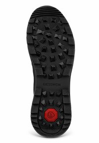 Schwarze Gummisohle mit einem strukturierten, genoppten Muster für Traktion, mit einem roten hexagonalen Akzent in der Mitte, markiert mit "GIESSWEIN."