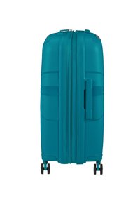 Valigia rigida color teal con superficie testurizzata, chiusura a zip, maniglia superiore e quattro ruote nere per la mobilità.