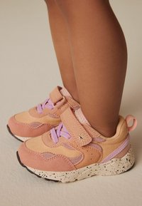 Velcro sneakers i pink og fersken med lilla accenter, tekstureret stof og spottet hvid sål. Rund tå og polstret krave.